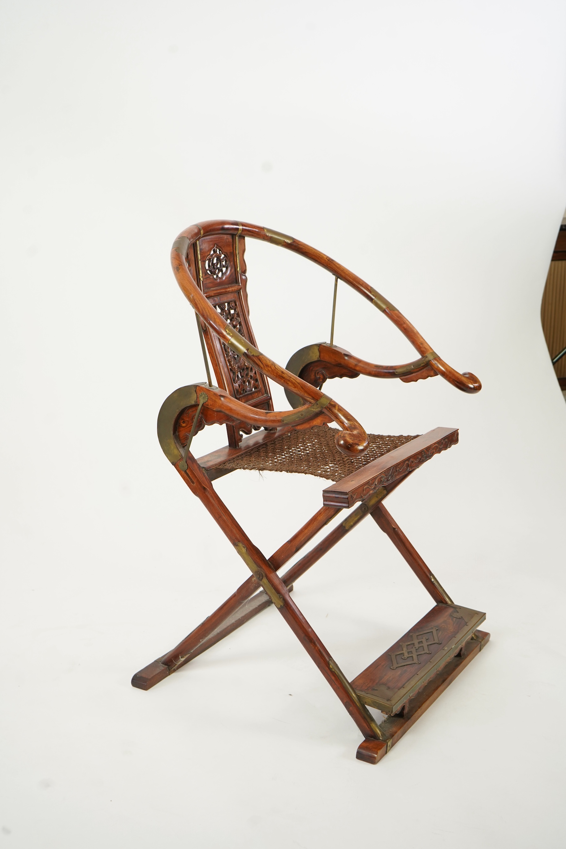 A Chinese huanghuali, hongmu and brass mounted folding hunting chair, jiaoyi, early 20th century
